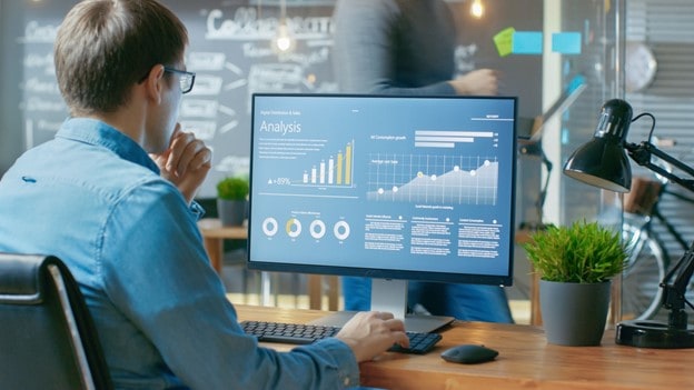 man looking at computer monitor