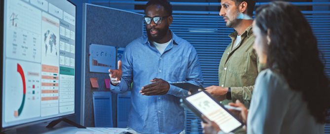 data analysts looking at large screen