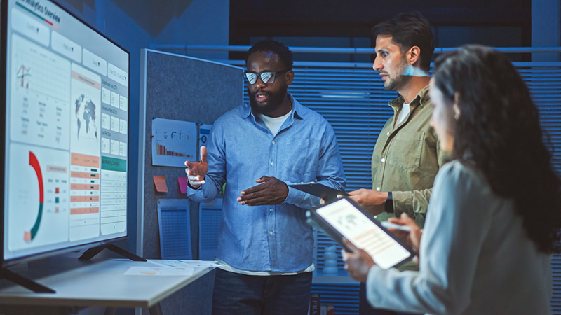 data analysts looking at large screen