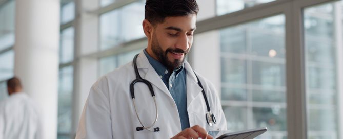male cardiologist using tablet