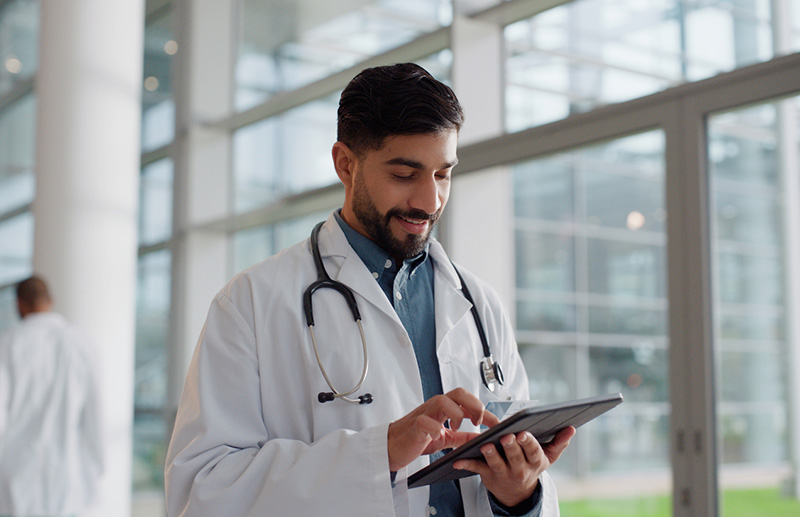 male cardiologist using tablet