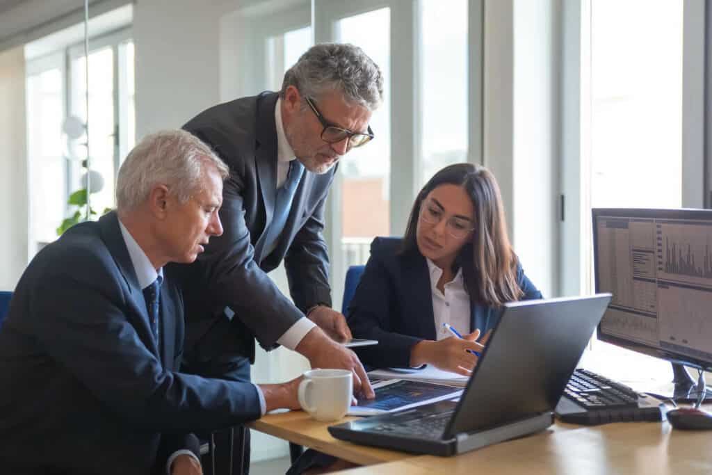 executives looking at a laptop